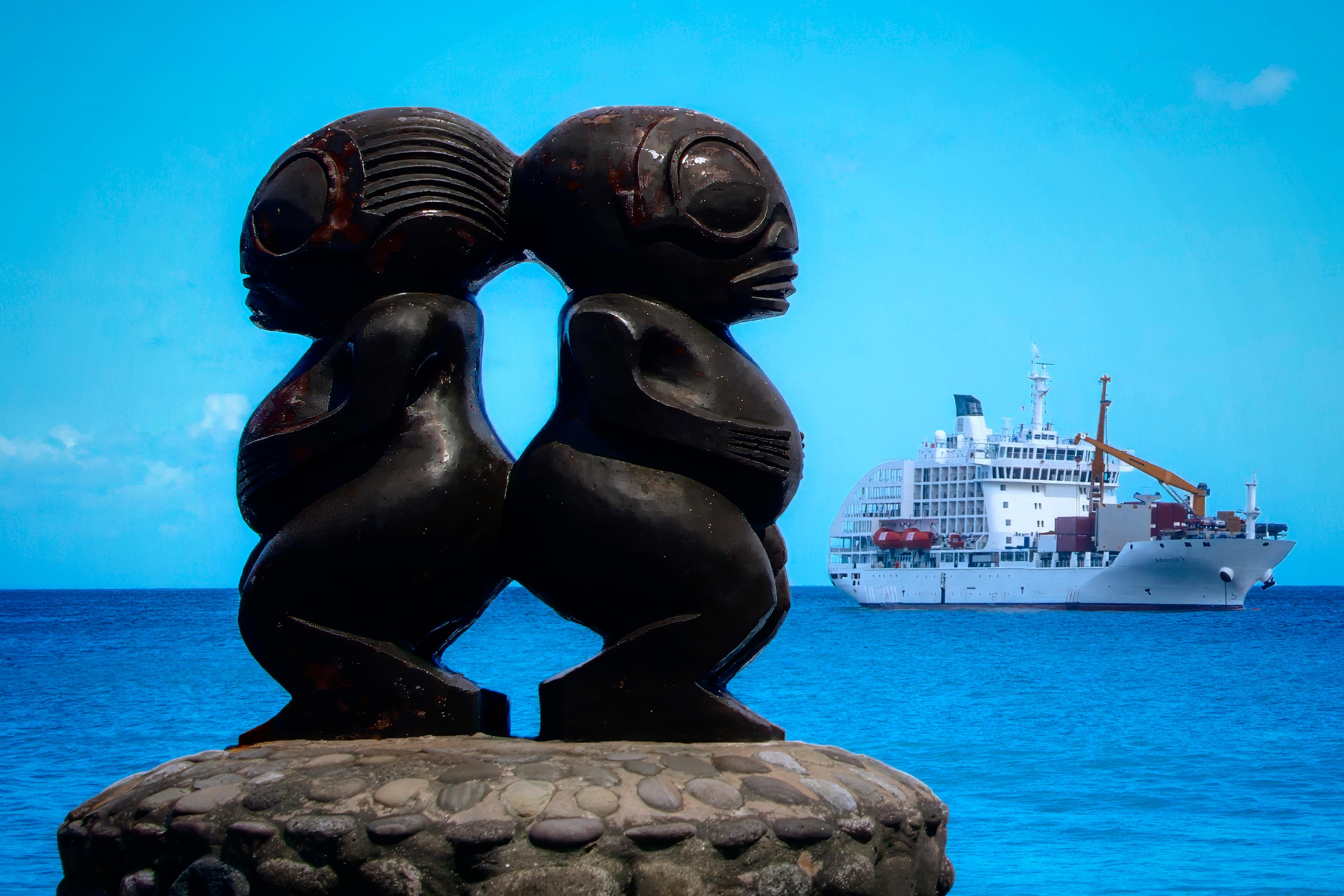 Modern twin tiki and the Aranui 5 at Fatu Hiva’s Omoa Bay. (Maria Coulson)