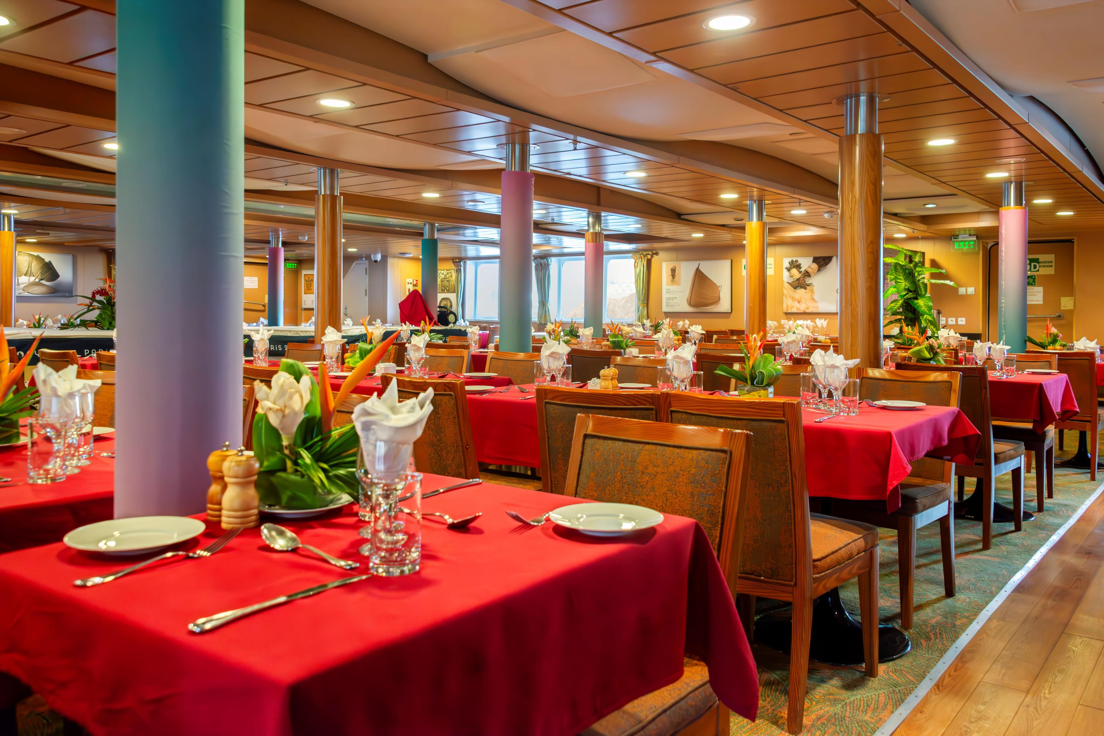 Beautiful flower arrangements and colorful tablecloths adorn the ship’s bright and inviting dining room. (Maria Coulson)