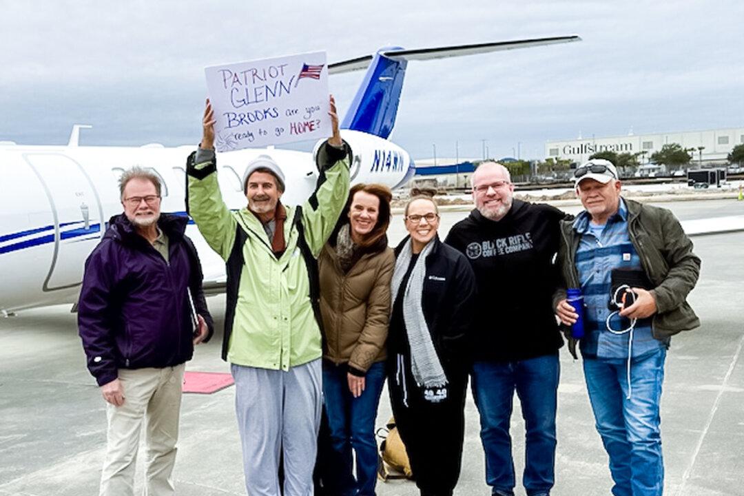 (L–R) Pilot Gary Heavin, former Jan. 6 prisoner Glenn Brooks, and volunteers Diane Heavin, Nicky Long, Tim Long, and pilot Mark Harrington posed for a group photo just before the first Operation Airlift flight prepares to take off in Savannah, Ga., on Jan. 21, 2025. (Courtesy of Claude Heavin)