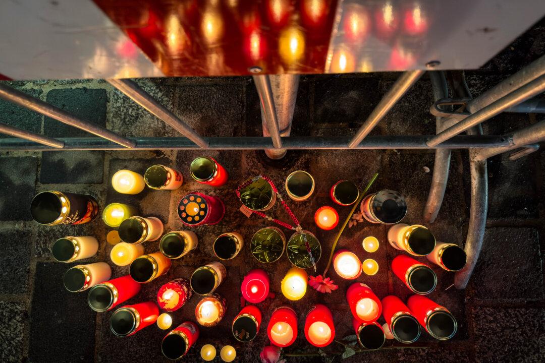 Candles are lit at the site of a stabbing attack in Villach, Austria, on Feb. 16, 2025. A 23-year-old man stabbed six passersby on Saturday that left a 14-year-old dead and five others injured. (Darko Bandic/AP Photo)