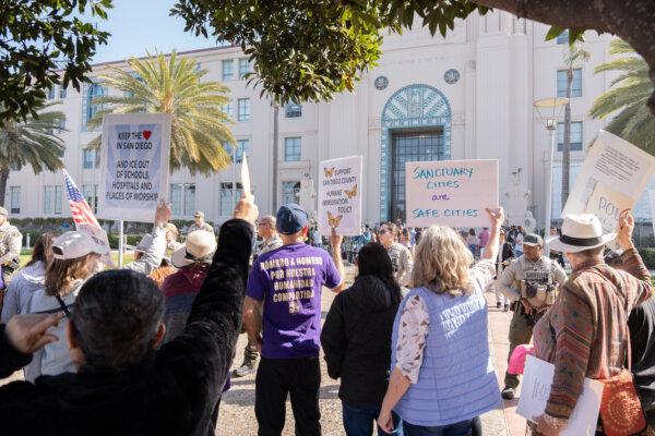 Protestor hold signs and chant nearby a press conference by California state Sen. Brian Jones when he announces SB 554, a new bill to overhaul state's sanctuary law, in front of the San Diego County Administration Building on Feb. 20, 2025. (Jane Yang/The Epoch Times)