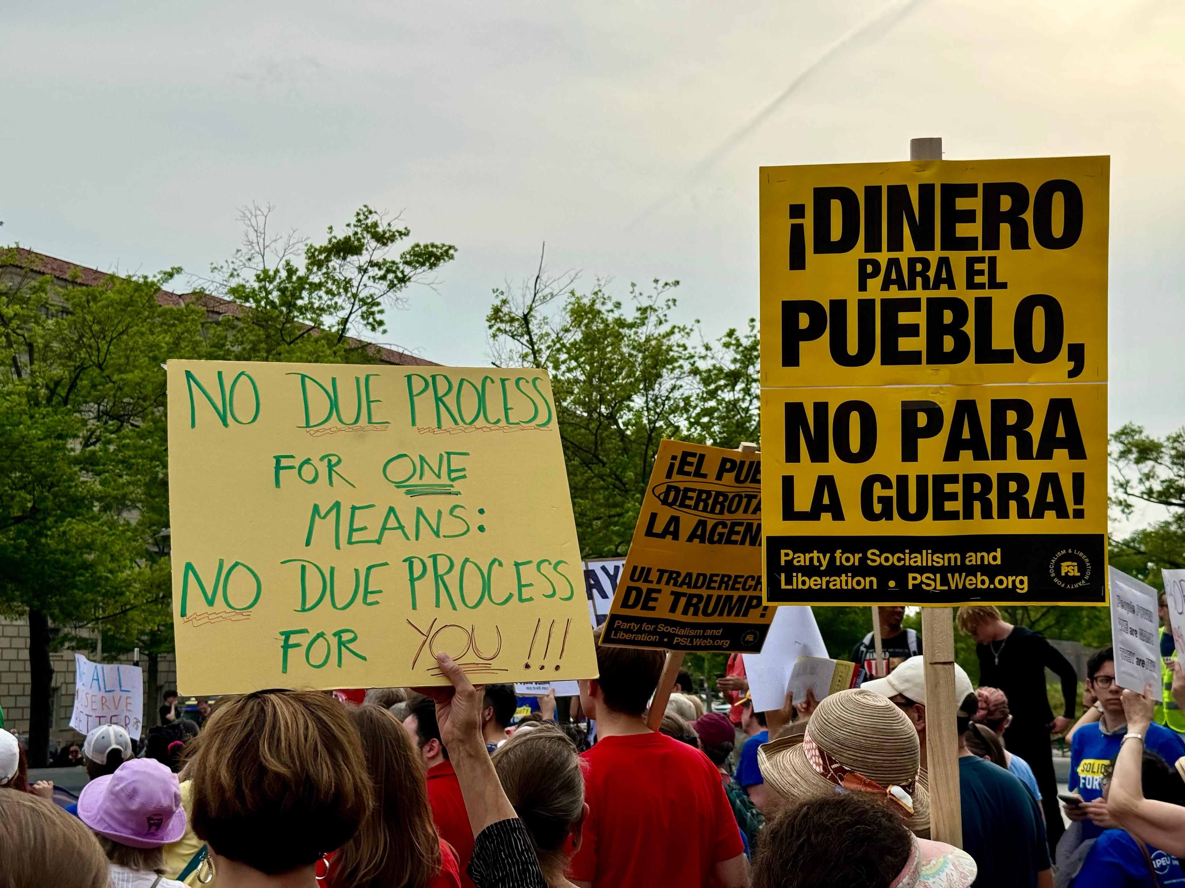 Protesters in Washington on May 1 hold up signs demanding due process for deportees. (Arjun Singh/The Epoch Times)
