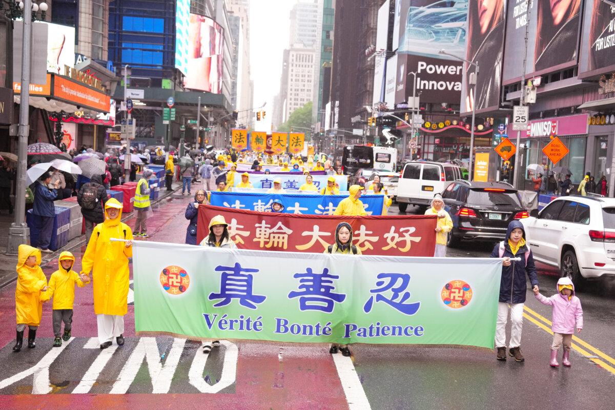 Falun Gong practitioners take part in a parade to celebrate World Falun Dafa Day and call for an end of the persecution in China, in New York City, on May 9, 2025. (Larry Dye/The Epoch Times)