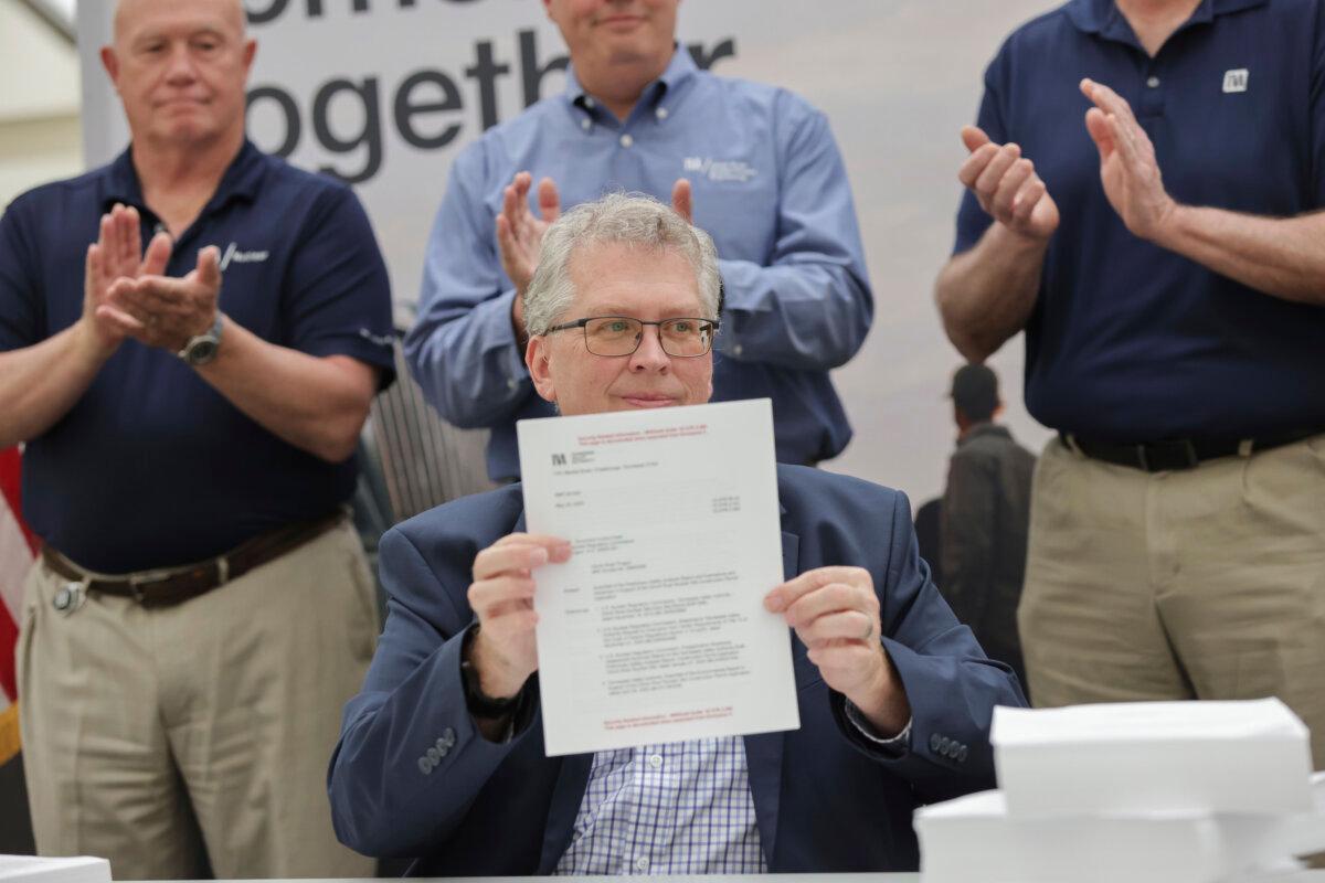 Tennessee Valley Authority New Nuclear Program Vice President Scott Hunnewell signs the construction permit application to build a GE Vernova Hitachi BWRX-300 small modular reactor in Clinch River, Tenn., on May 19, 2025, the first licensed and commissioned in the United States. (Tennessee Valley Authority via AP)