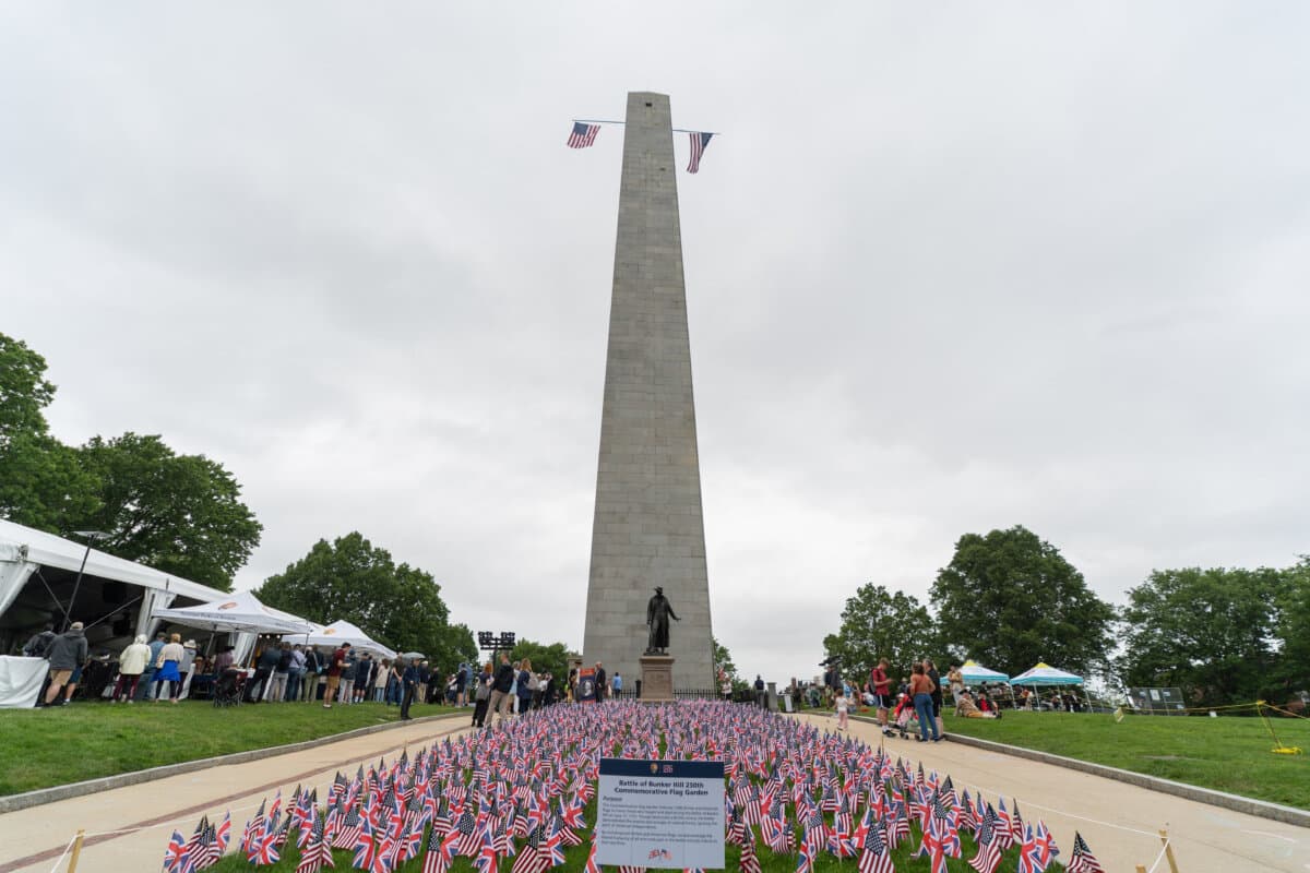 American and British flags are planted in front of Bunker Hill Monument to commemorate the 250th anniversary of the Battle of Bunker Hill, in Boston on June 17, 2025. (Learner Liu/The Epoch Times)