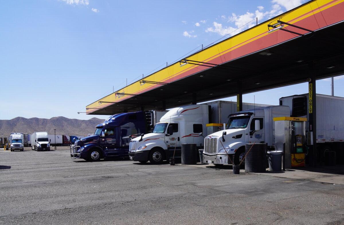 Tractor-trailer rigs line up to refuel at Love's Travel Center in Eloy, Ariz., on Aug. 23, 2025. (Allan Stein/The Epoch Times)
