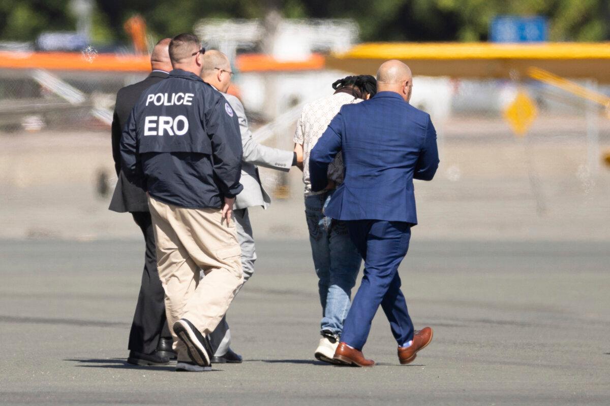 Harjinder Singh is escorted to an airplane by Florida Lt. Gov. Jay Collins and law enforcement in Stockton, Calif., on Aug. 21, 2025. (Benjamin Fanjoy/AP Photo)