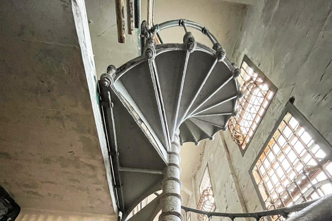 A spiral staircase inside the main cell building at the former prison on Alcatraz Island on Sept. 9, 2025. (Allan Stein/The Epoch Times)