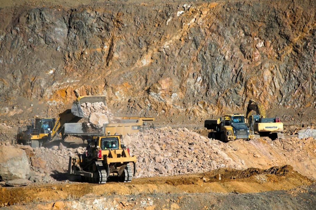 Wheel loaders load trucks with ore at the MP Materials rare earth mine in Mountain Pass, Calif., on Jan. 30, 2020. Until this summer, it was the only rare earth mine in the United States. (Steve Marcus/Reuters)