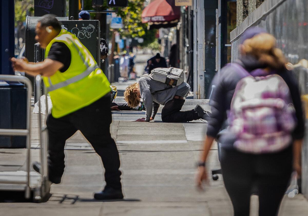 A young man works off a fentanyl high in the Tenderloin district of San Francisco on May 16, 2024. (John Fredricks/The Epoch Times)