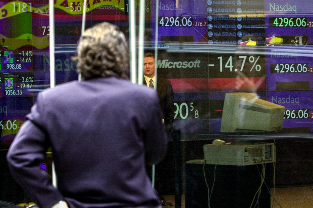 Onlookers check the trading numbers for both Microsoft, down 14.7 percent at the time, and the NASDAQ exchange, on the floor of the NASDAQ Marketsite on Times Square in New York City on April 3, 2000. The last time markets were so highly concentrated was during the apex of the dot-com bubble in 2000. (Henny Ray Abrams/AFP via Getty Images)