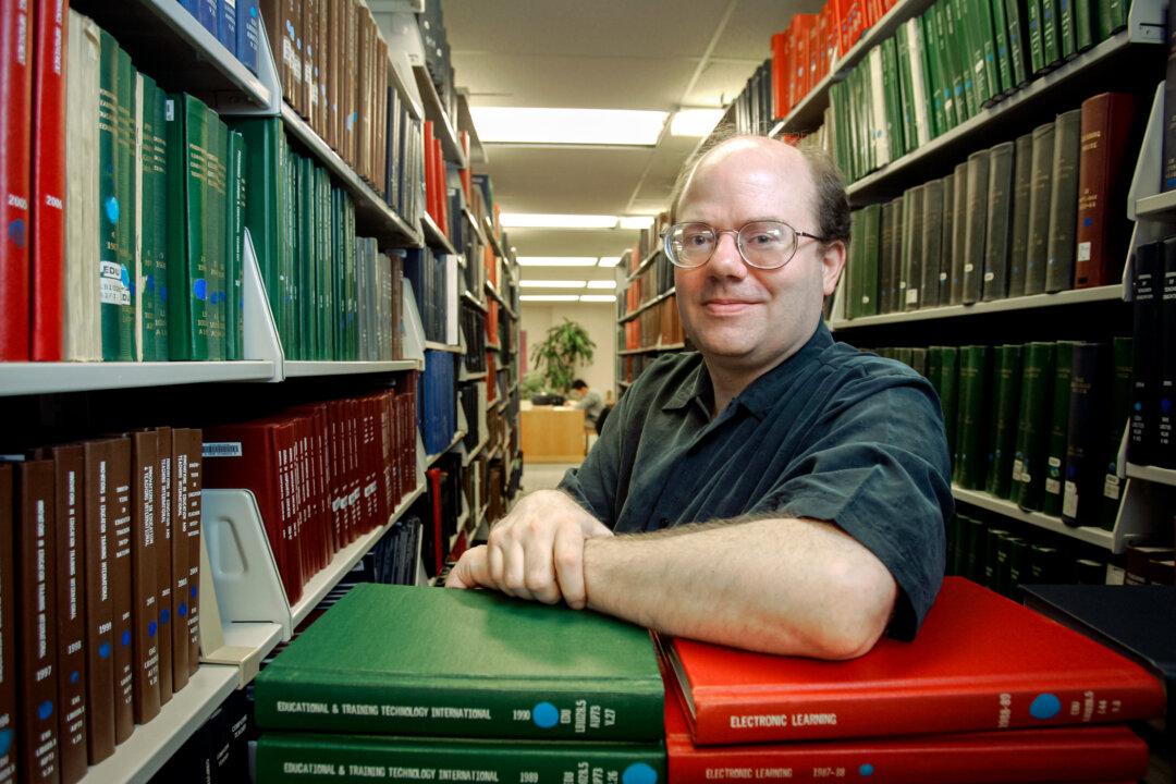 Larry Sanger, cofounder of Wikipedia and former philosophy professor, among stacks of reference books at a library in Columbus, Ohio, on March 26, 2007. (Kiichiro Sato/AP Photo)