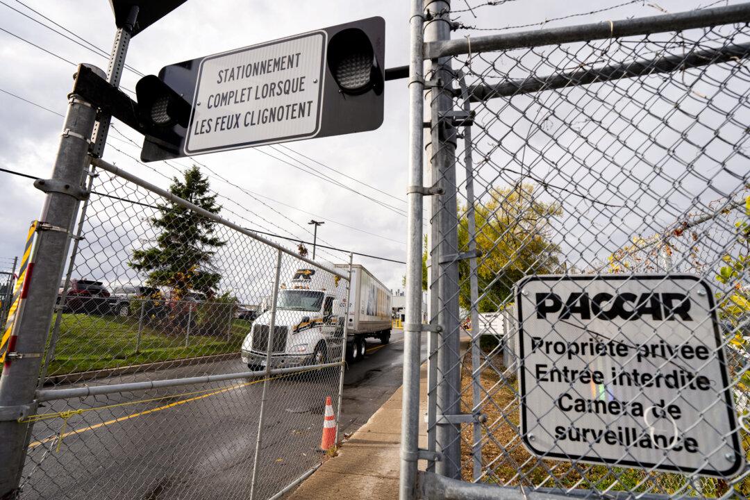A truck exits U.S. truck manufacturer Paccar Inc.’s commercial truck plant in Sainte-Thérèse, Canada, on Oct. 22, 2025. After President Donald Trump signed a truck-tariff proclamation on Oct. 17, Paccar’s stock rose by 3 percent and kept climbing, reaching a monthly high in the following days. (Christinne Muschi/The Canadian Press)