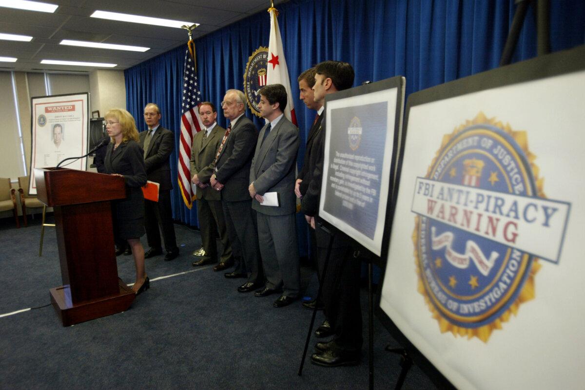 FBI Cyber Division Assistant Director Jana Monroe speaks near a large warning label at a press conference in Los Angeles on Feb. 16, 2004. (David McNew/Getty Images)