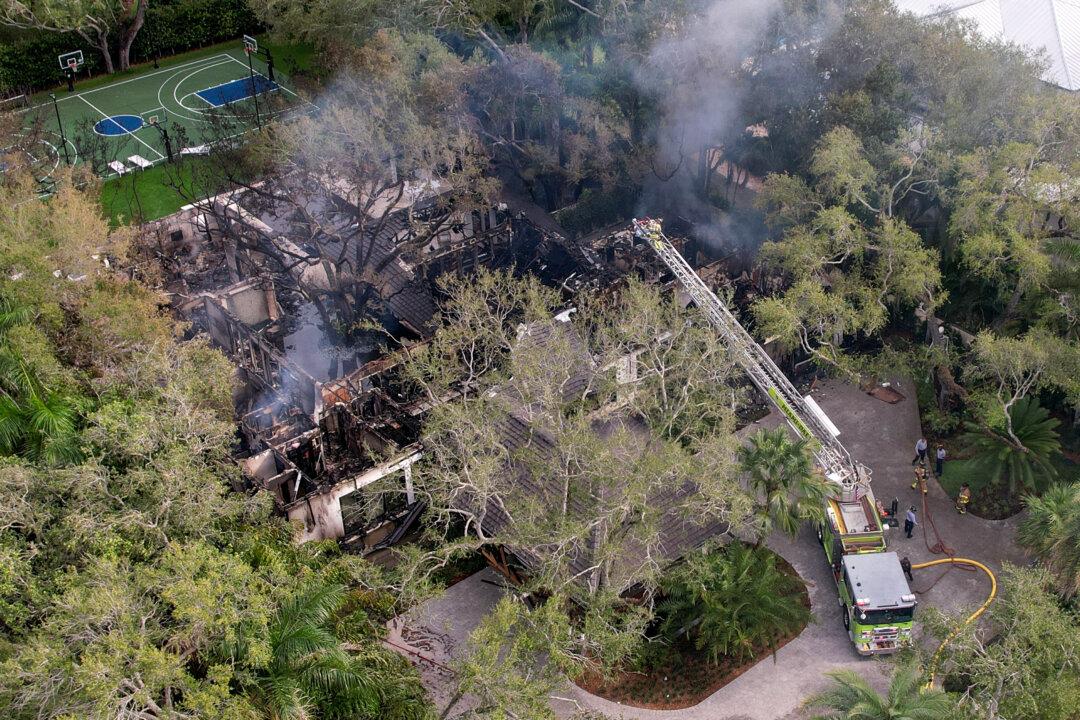 Firefighters work to extinguish the remains of a fire at a home owned by Miami Heat basketball coach Erik Spoelstra in Miami, on Nov. 6, 2025. (Rebecca Blackwell/AP Photo)