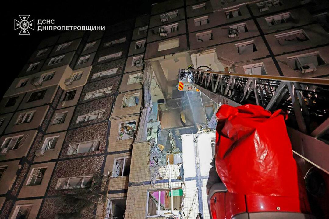 In this photo provided by the Ukrainian Emergency Service, firefighters put out a fire following a Russian rocket attack that hit a multi-story apartment building in Dnipro, Ukraine, on Nov. 8, 2025. (Ukrainian Emergency Service via AP)