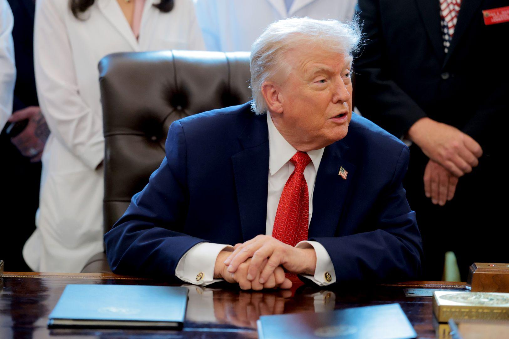 U.S. President Donald Trump speaks to journalists after signing an executive order in the Oval Office of the White House on Dec. 18, 2025. (Anna Moneymaker/Getty Images)
