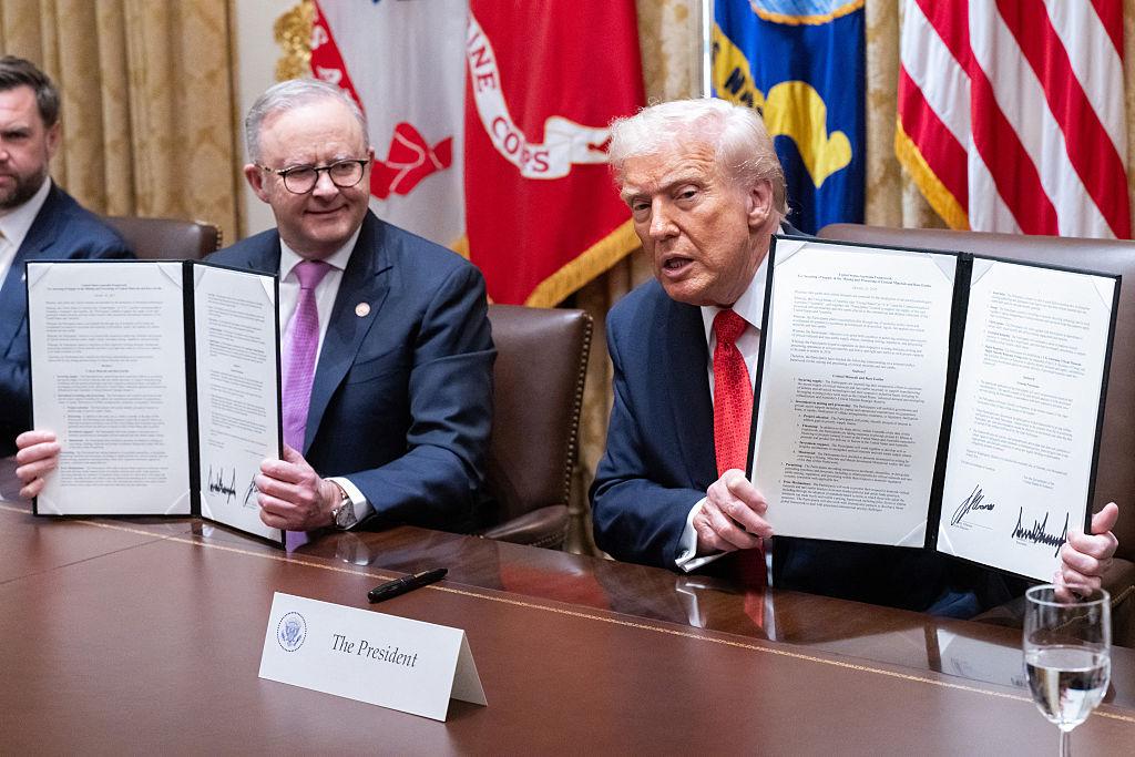 US President Donald Trump (R) and Australia's Prime Minister Anthony Albanese display an agreement on critical minerals they signed in the Cabinet Room at the White House in Washington, DC, on Oct. 20, 2025. (Saul Loeb/AFP via Getty Images)