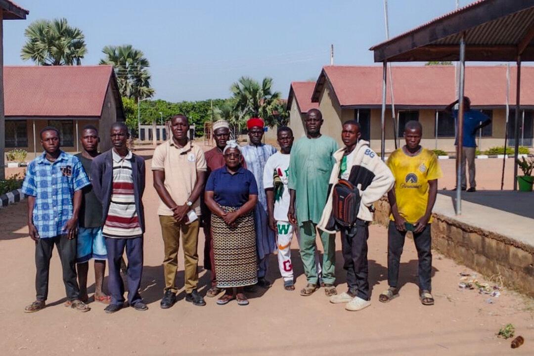 People pose for a photograph at St. Mary's Catholic Primary and Secondary School after armed men abducted children and staff in Papiri, Nigeria, on Nov. 21, 2025. (Christian Association of Nigeria via AP)