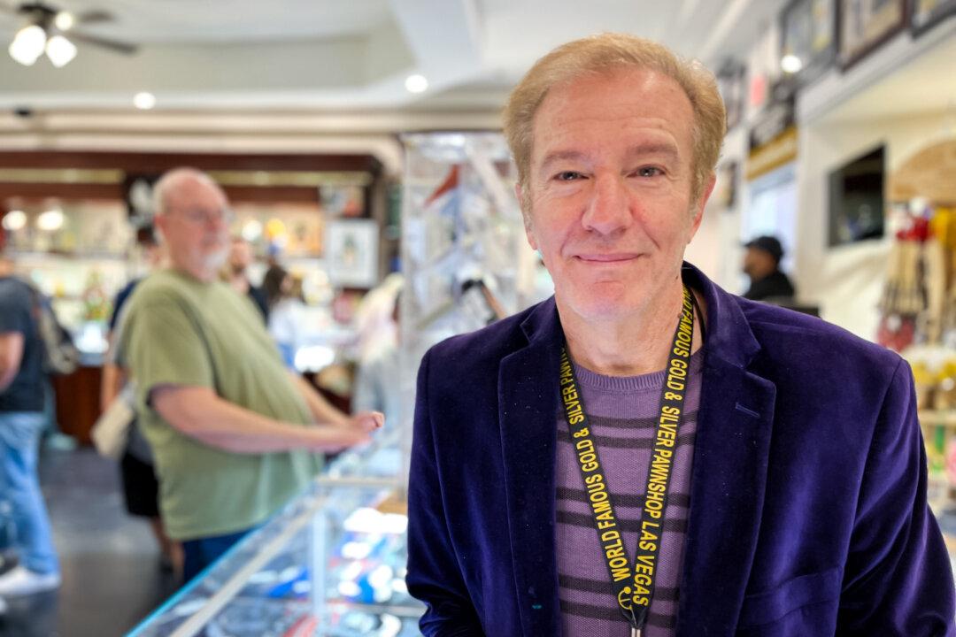 Chief financial officer Andy Zimmerman stands behind the counter at the Gold &amp; Silver Pawn Shop in Las Vegas on Dec. 9, 2025. Visitor numbers have steadily dwindled this year, and with tighter wallets, an uncertain economy, and hidden fees, the city is getting harder to sell to travelers, Zimmerman said. (Allan Stein/The Epoch Times)