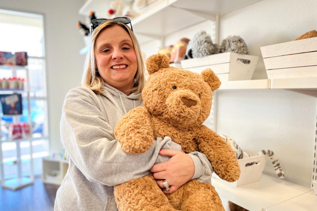 Sales associate Jennie Catanzariti holds a stuffed Jellycat at Bellies to Babies children’s store in Las Vegas on Dec. 9, 2025. Catanzariti said local businesses are concerned about having fewer visitors from the United States and other countries. (Allan Stein/The Epoch Times)