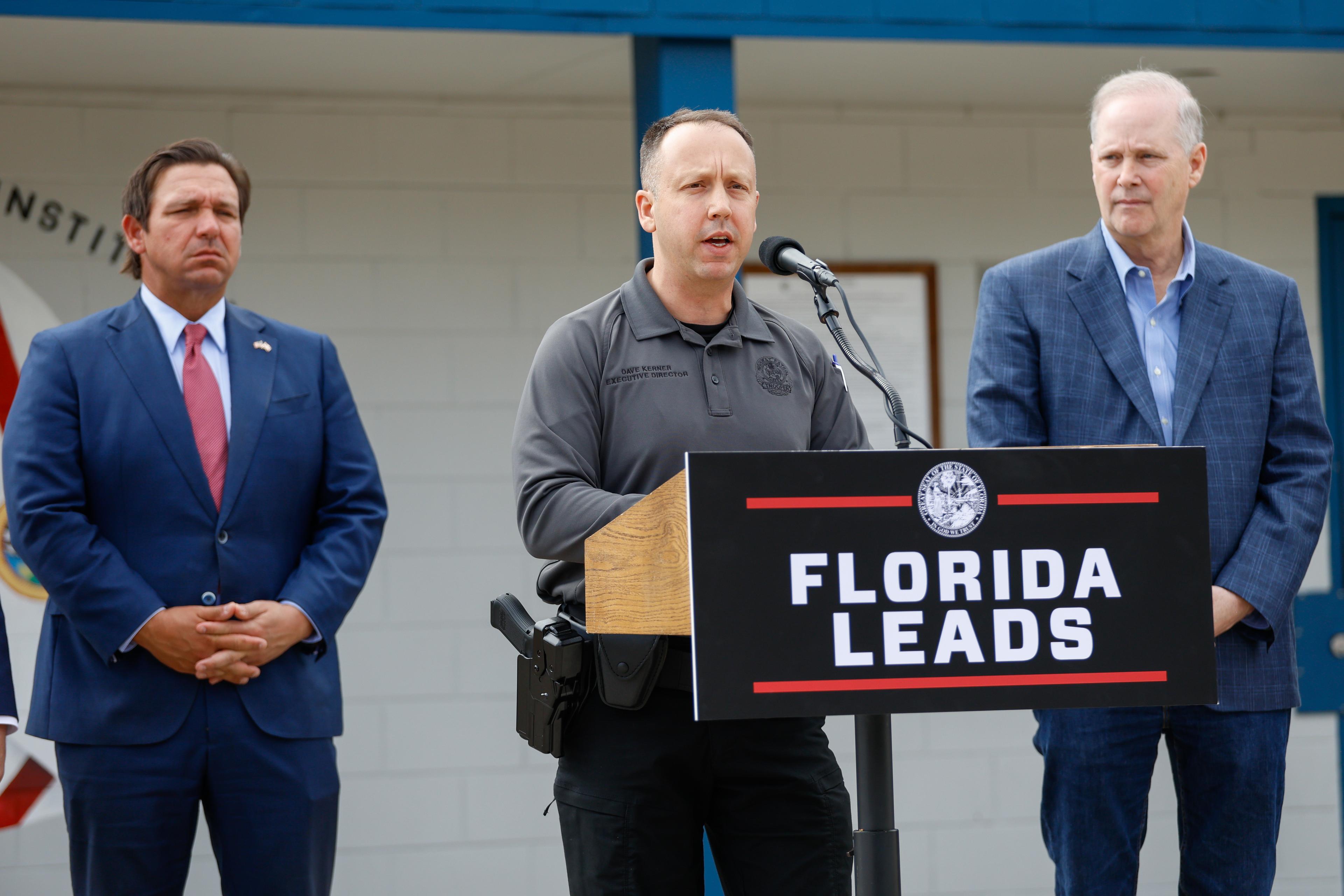 Dave Kerner (C), executive director of the Florida Department of Highway Safety and Motor Vehicles, describes the state's collaborative efforts with the federal government in immigration enforcement while speaking at a press conference at Deportation Depot in Sanderson, Fla., on Jan. 5, 2026. (Natasha Holt for The Epoch Times)