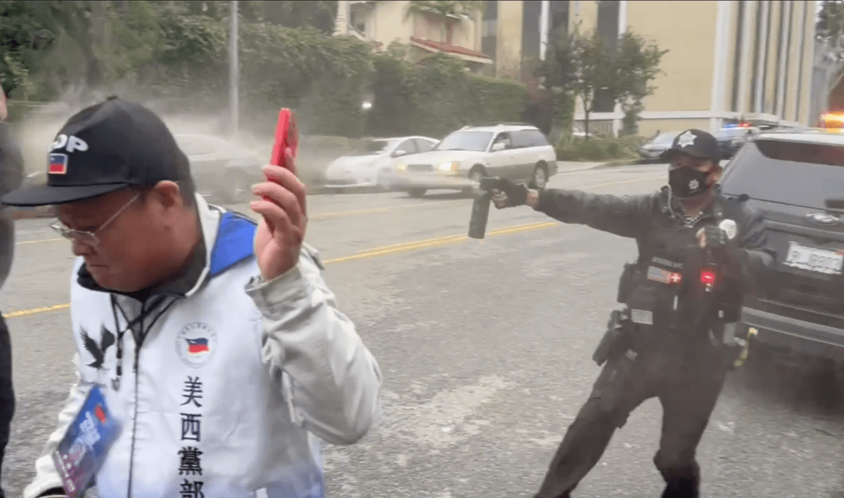 Wu Xian, a security guard, fires pepper spray at pro-democracy activists outside the Chinese Consulate in Los Angeles on Jan. 4, 2026. (Screenshot via The Epoch Times)