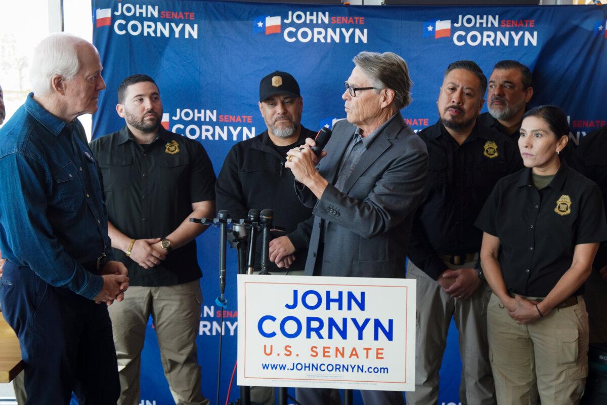 Sen. John Cornyn (R-Texas) and former Texas Gov. Rick Perry are flanked by members of the National Border Control Council at a rally for Cornyn's Senate primary campaign in Austin, Texas, on Feb. 17, 2026. (Nathan Worcester/The Epoch Times)