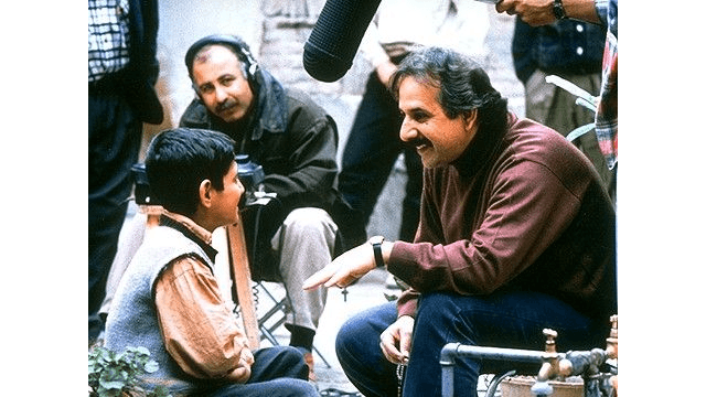 Child actor Amir Farrokh Hashemian and director Majid Majidi on the set of “Children of Heaven.” (Miramax)