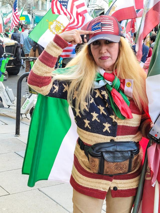 A woman who identified herself as “Anita” shows off her pro-U.S. and pro-Iranian attire as she and others celebrate the U.S.–Israeli strikes against Iran during a march in Washington on Feb. 28, 2026. (Stacy Robinson/The Epoch Times)