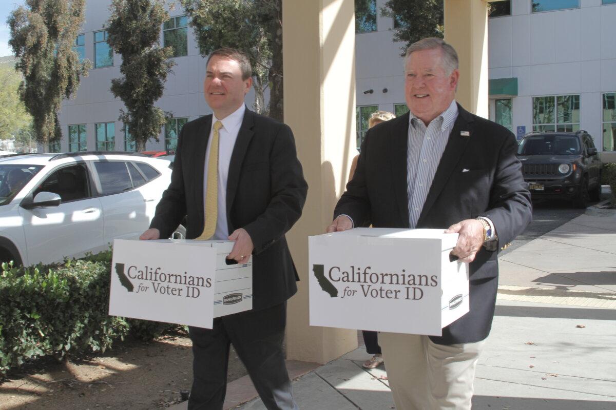 State Assemblyman Carl DeMaio (L) and Rep. Ken Calvert (R-Calif.) carry boxes of signed petitions to the Riverside County Registrar of Voters office in Riverside, Calif., on March 2, 2026. (Brad Jones/The Epoch Times)