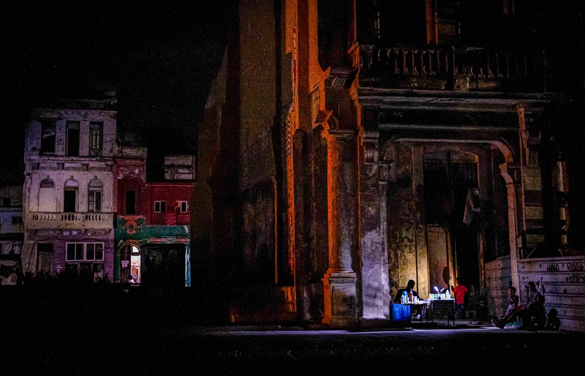 People gather outside a building during a blackout in Havana on March 16, 2026. (Adalberto Roque/AFP via Getty Images)