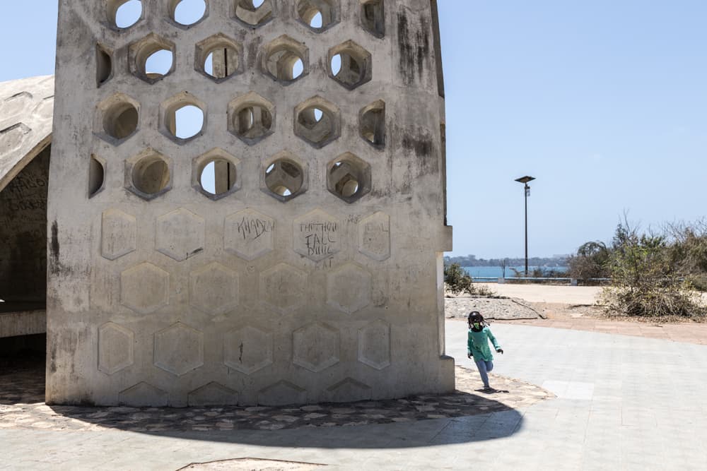 A girl runs around Goree's Memorial monument on Goree Island in Dakar, Senegal, on March 26, 2026. (Patrick Meinhardt/AFP via Getty Images)