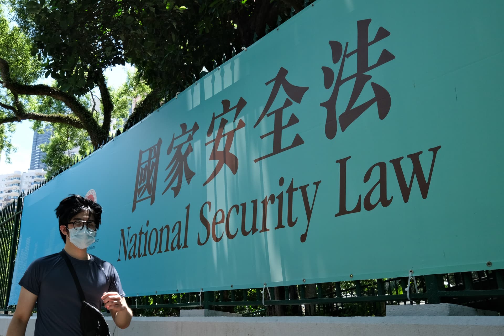 A man walks past a public notice banner for the National Security Law in Hong Kong on July 15, 2020. (Anthony Wallace/AFP via Getty Images)