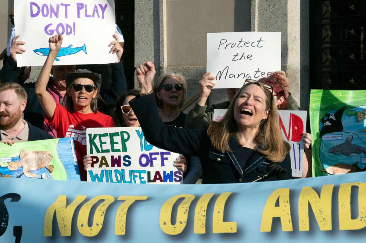 Susan Holmes, executive director of the Endangered Species Coalition, right, speaks in front of the Interior Department building during a rally to oppose the Trump administration's convening of the Endangered Species Committee, in Washington on March 31, 2026. (Cliff Owen/AP Photo)