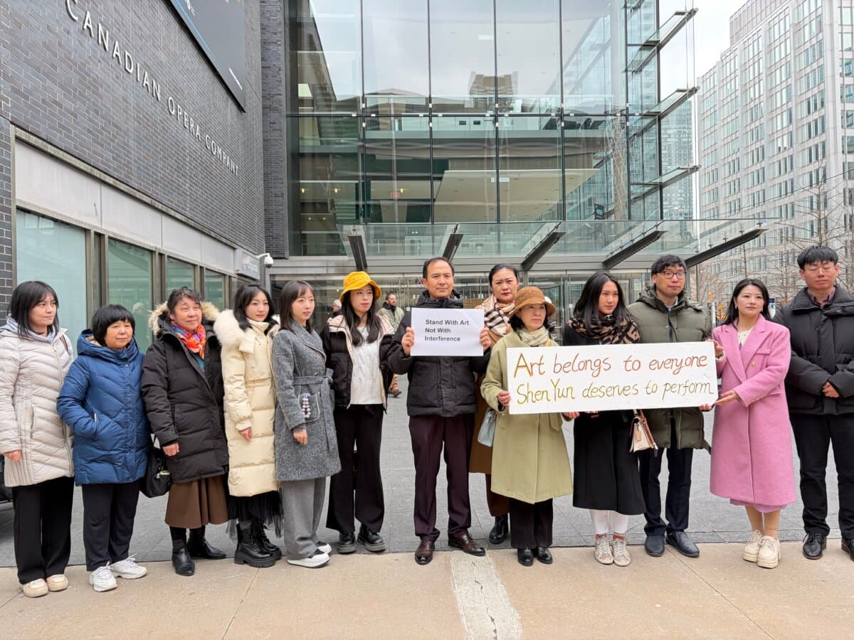 A group shows their support for Shen Yun after the performances were cancelled by the theatre over a bomb threat that police said was unfounded, outside the Four Seasons Centre for the Performing Arts in Toronto on April 1, 2026. (Teng Dongyu/The Epoch Times)