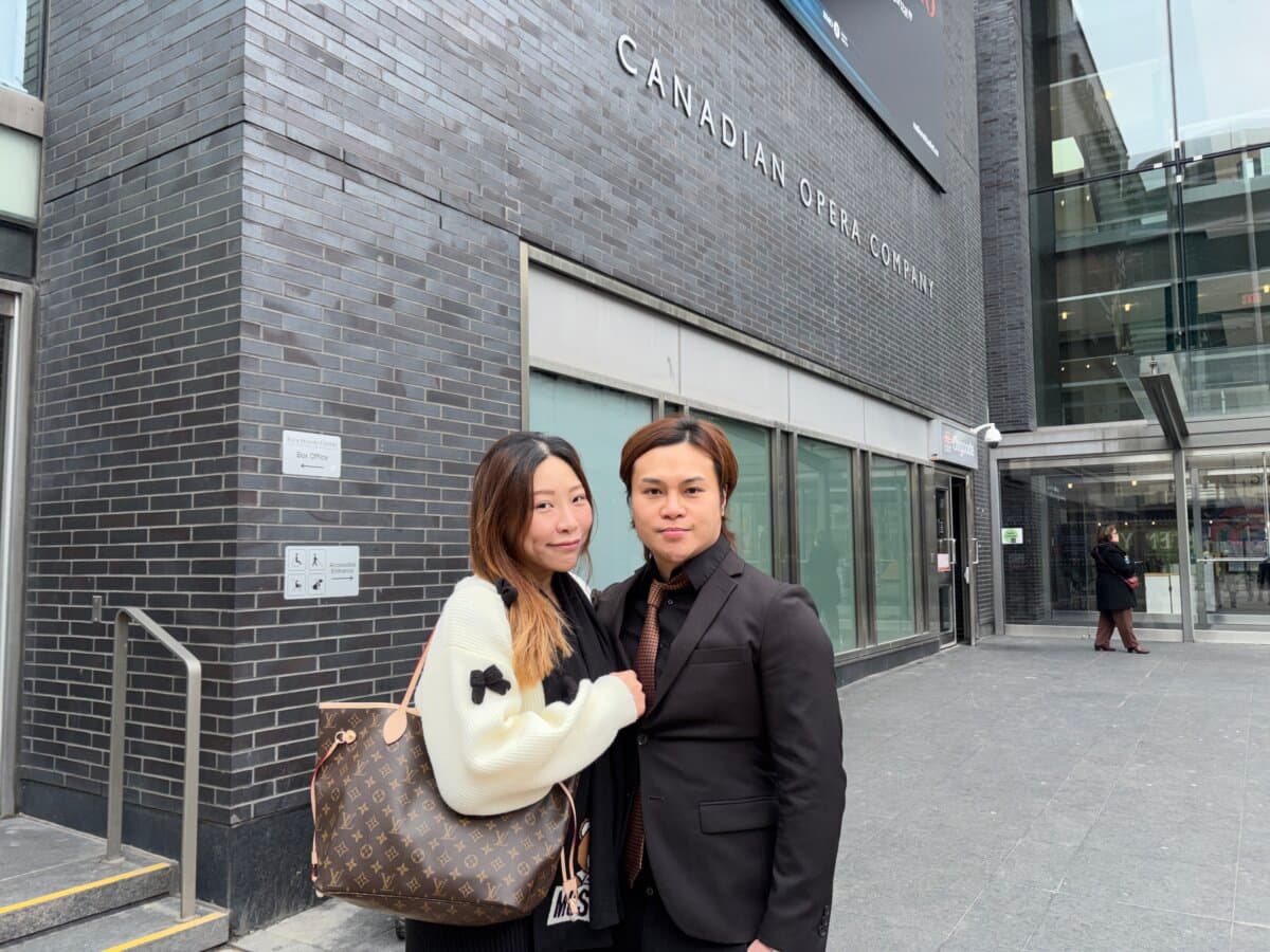 Kui Teng, a Hong Kong kickboxing champion, and his wife outside the Four Seasons Centre for the Performing Arts in Toronto, where Shen Yun was scheduled to perform, on April 1, 2026,. (Teng Dongyu/The Epoch Times)