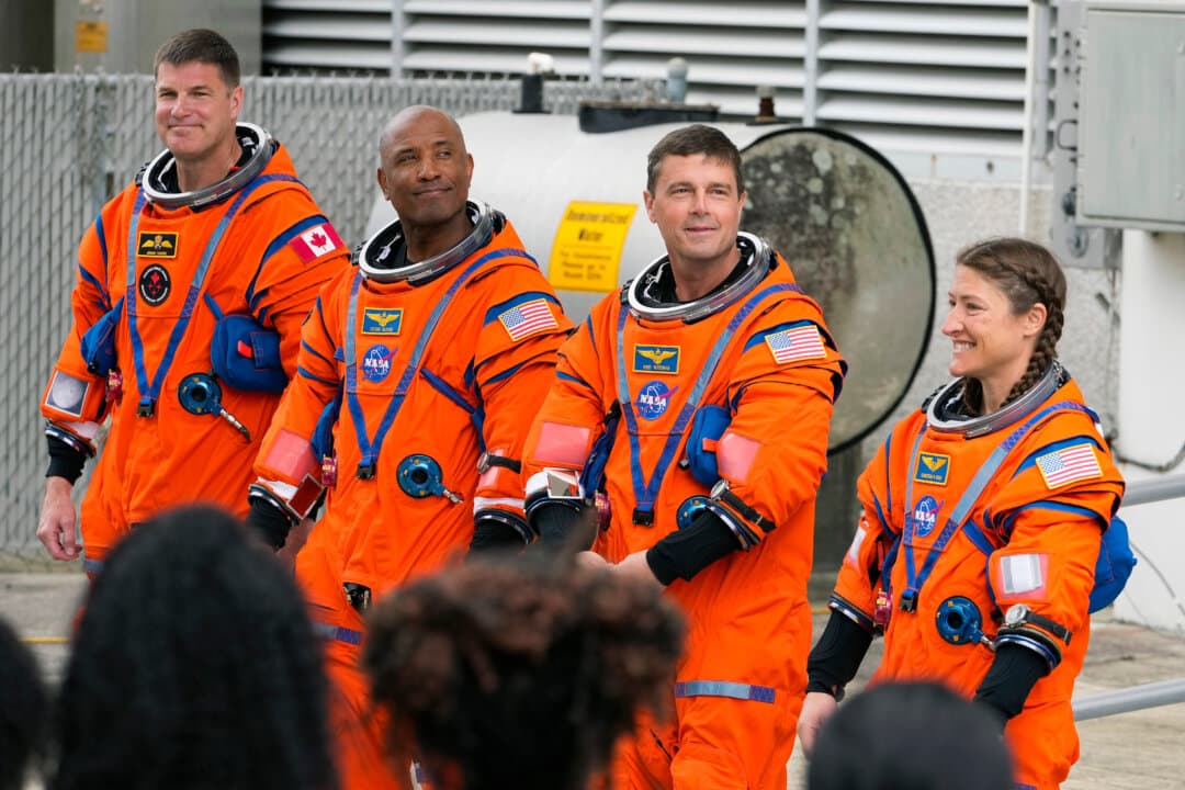 (L-R) Astronauts Mission Specialist Jeremy Hansen, of Canada, Pilot Victor Glover, Commander Reid Wiseman, and Mission Specialist Christina Koch pose for a photo after leaving the Operations and Checkout Building for a trip to Launch Pad 39B and a planned liftoff on NASA’s Artemis II moon rocket at Kennedy Space Center in Cape Canaveral, Fla., on April 1, 2026. (Chris O'Meara/AP Photo)