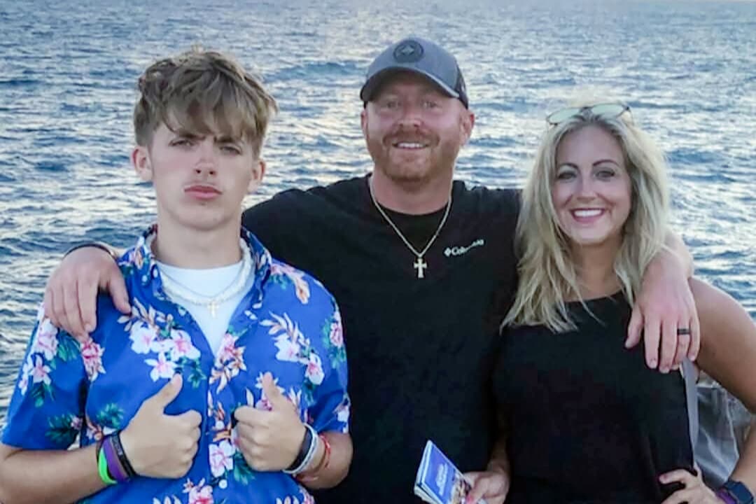 (L–R) Bryce Tate poses with his parents, Adam and Amanda, in this file photo. The 15-year-old took his own life in November 2025 after an hours-long exchange with an online predator. (Courtesy of Adam Tate)