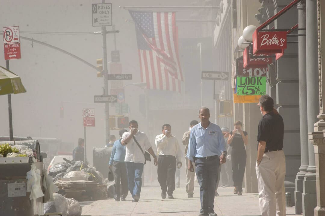 People flee as the World Trade Center collapses after two hijacked planes struck the towers in a terrorist attack in New York City on Sept. 11, 2001. (Spencer Platt/Getty Images)