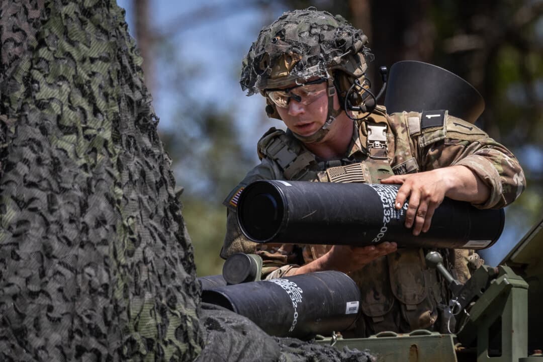 Soldiers of the United States Army practice combat exercises with 120mm mortar rounds at Fort Benning, Ga., on April 9, 2026. (John Fredricks/The Epoch Times)