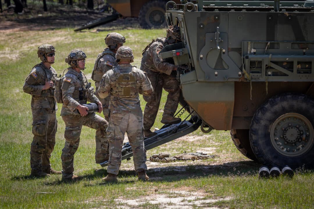 Soldiers of the United States Army perform combat exercises with 120mm mortar rounds at Fort Benning, Ga., on April 9, 2026. (John Fredricks/The Epoch Times)