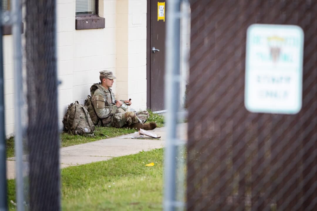 A soldier of the United States Army sits before participating in combat exercises at Fort Benning, Ga. on April 10, 2026. (John Fredricks/The Epoch Times)