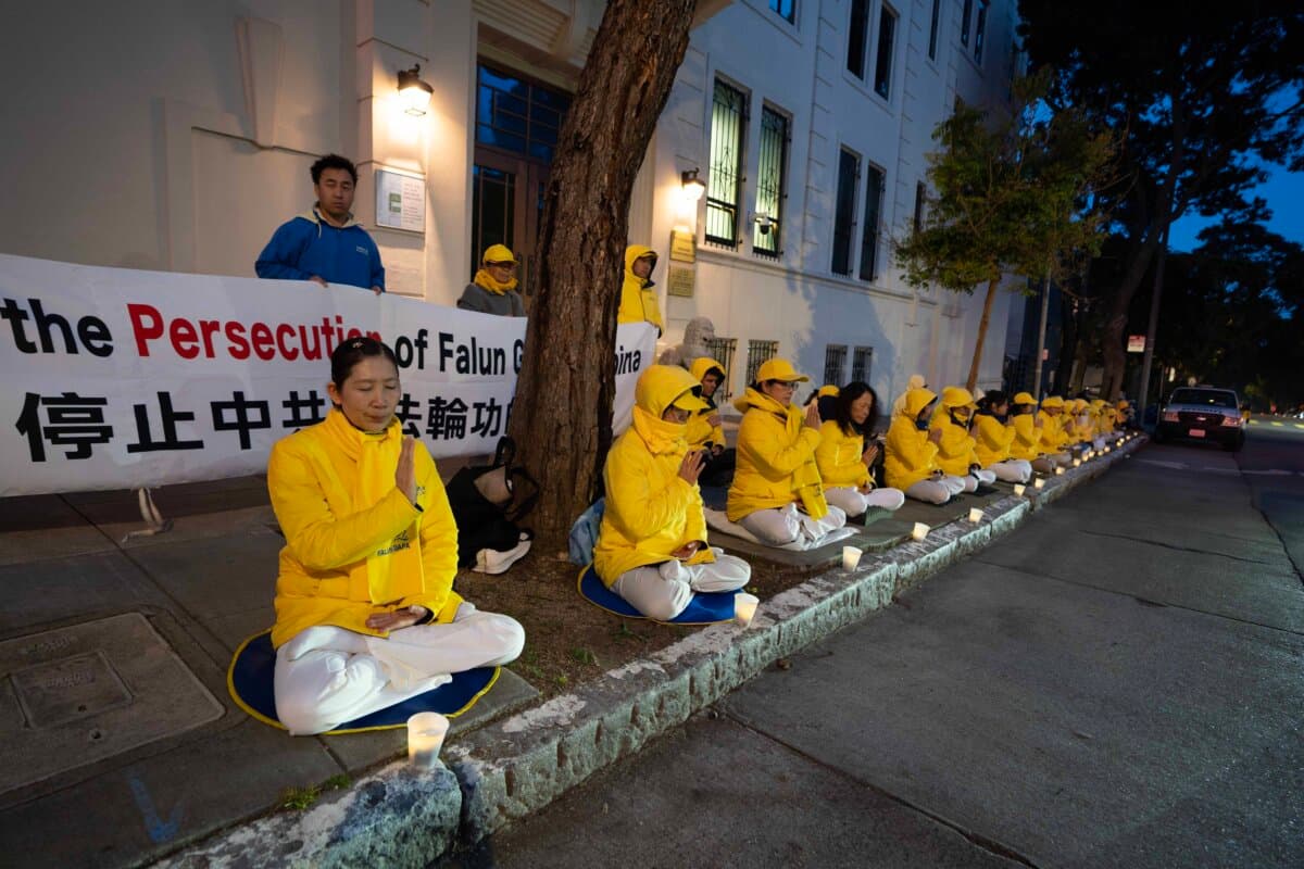 Falun Gong practitioners hold a candlelight vigil in front of the San Francisco Chinese Consulate on April 24, 2026, in remembrance of victims of the persecution in China. (Gary Wang/The Epoch Times)