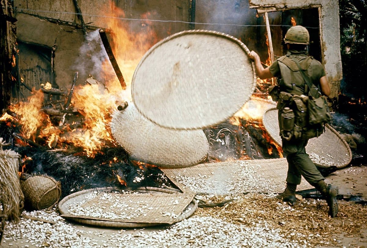 A U.S. soldier burning down a dwelling during the My Lai massacre. (Public Domain)