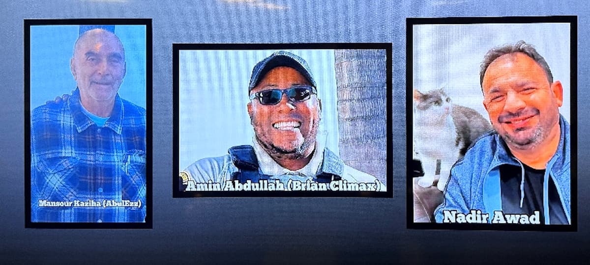 A video monitor shows images of Mansour Kaziha, security guard Amin Abdullah, also known to friends as Brian Climax, and Nadir Awad, who were killed during a shooting attack at the Islamic Centre of San Diego, during a news conference at police headquarters in San Diego, Calif., on May 19, 2026. (Arafat Barbakh/Reuters)