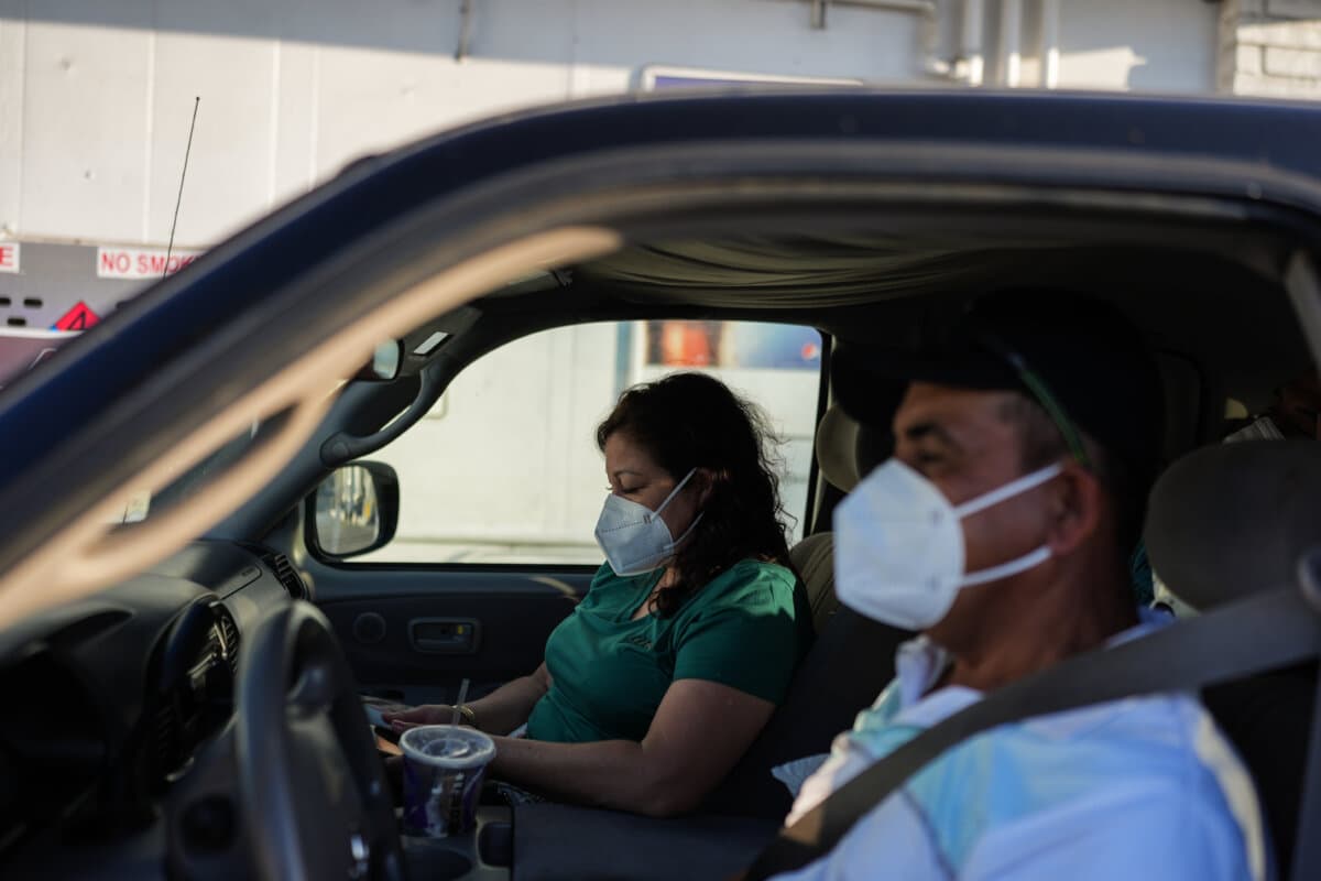 Two evacuees sit in their pickup truck at a gas station within the evacuation zone in Stanton, Calif., on May 25, 2026. (AP Photo/Jae C. Hong)