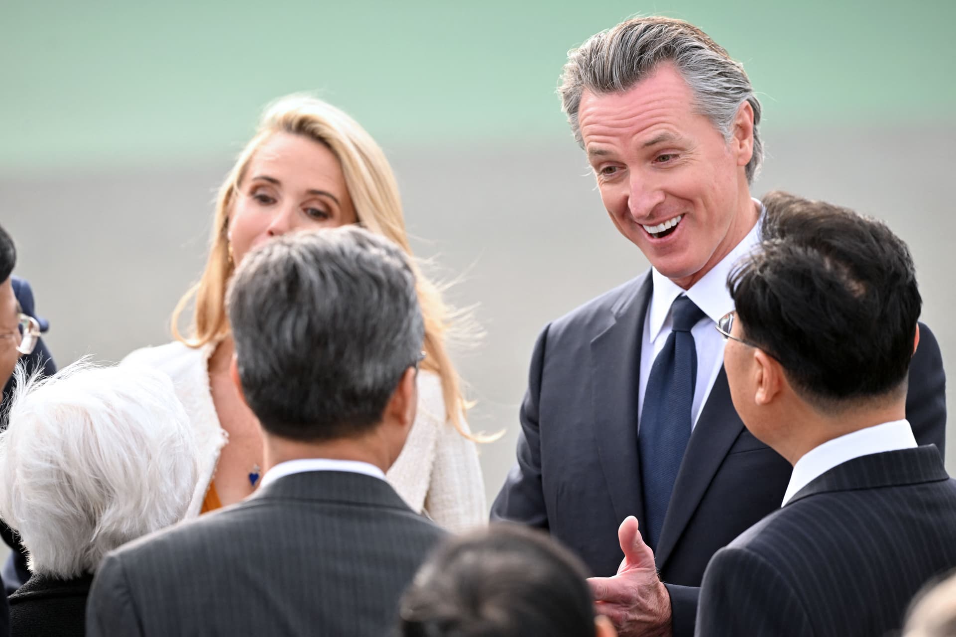 California Gov. Gavin Newsom meets with Chinese officials on the tarmac ahead of Chinese leader Xi Jinping's arrival at San Francisco International Airport on Nov. 14, 2023. (Frederic J. Brown/AFP via Getty Images)