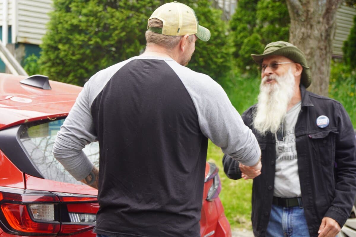 Graham Platner greets a supporter at a campaign event in Belfast, Maine, on June 6, 2026, just days ahead of the state's June 9 primary. (Nathan Worcester/The Epoch Times)