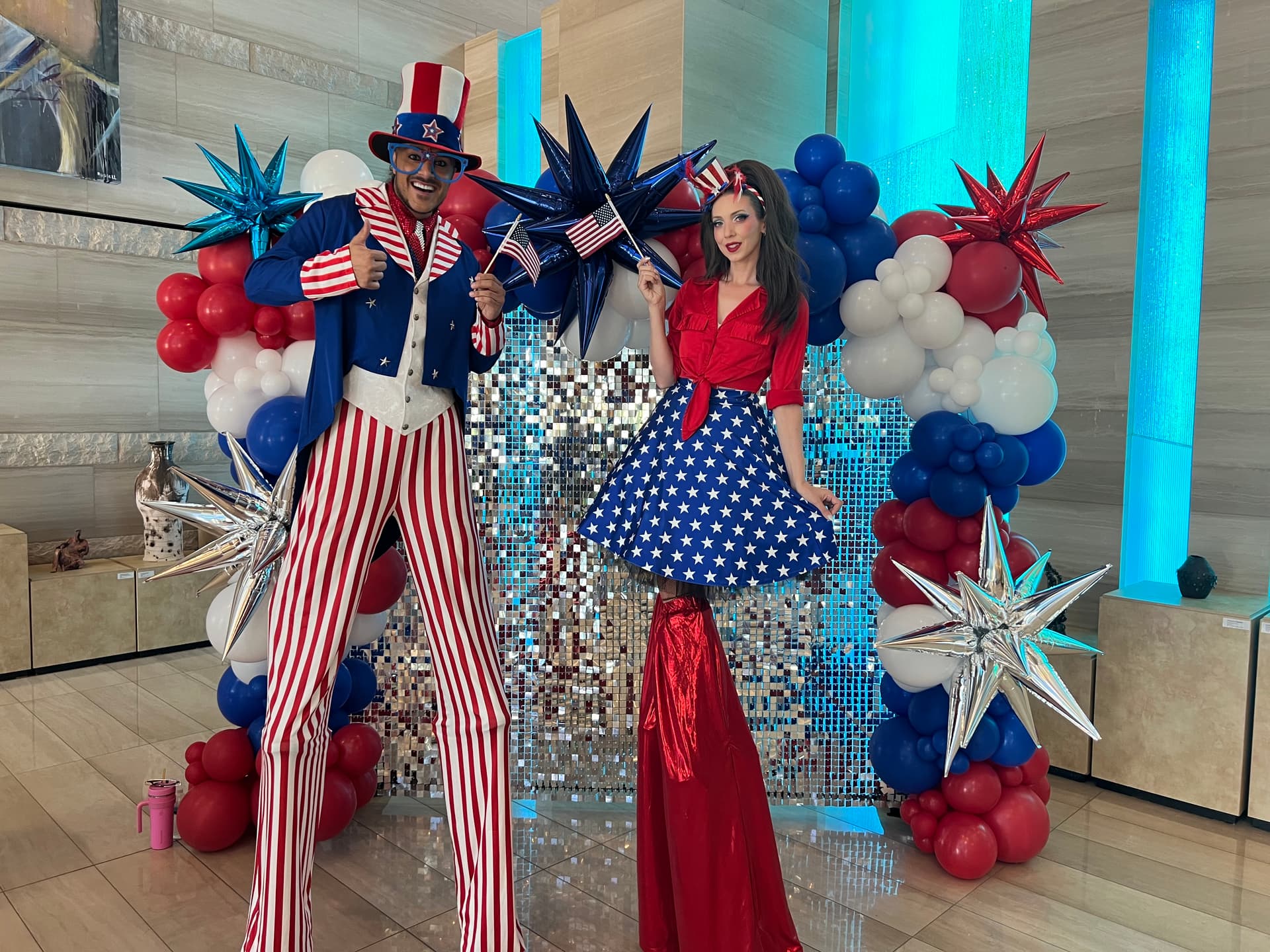 Patriotic stilt-walkers Jeffrey DeBarathy and Sarah Roberts greeted voters at the Las Vegas City Hall during the primary election on June 9, 2026. (Jacki Thrapp/The Epoch Times)